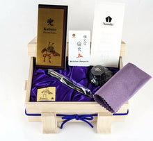 Load image into Gallery viewer, The fountain pen arranged in the presentation box with the certificates,ink bottle, and lavender cloth.