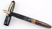 Load image into Gallery viewer, The fountain pen's grip section leaning on the cap.