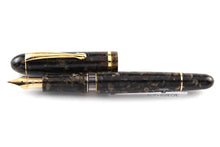 Load image into Gallery viewer, Front view of the brown fountain pen with the cap set next to it.