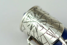 Load image into Gallery viewer, Close up to a star decoration on the cap's silver overlay.