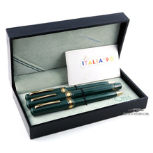 Load image into Gallery viewer, The fountain pen, ballpoint, and pencil arranged in the presentation box with the booklet. The interior lid has a blue ink mark.