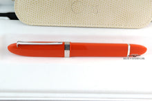 Load image into Gallery viewer, Side view of the orange pen in the presentation box.