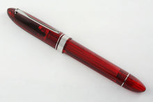 Load image into Gallery viewer, Angled front view of the red rollerball pen with the cap on.