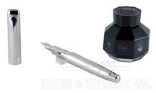 Load image into Gallery viewer, The fountain pen and cap arranged with a black ink bottle.