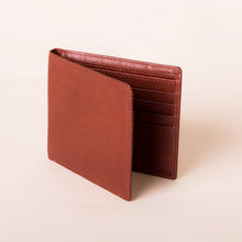Load image into Gallery viewer, Angled front view of the brandy leather wallet.