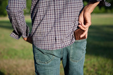 Load image into Gallery viewer, A young man pulling a wallet from his pants' back pocket.