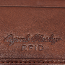 Load image into Gallery viewer, Close up to the Osgoode Marley RFID embossed logo on the brandy wallet.