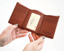 Load image into Gallery viewer, Two hands holding the brandy brown wallet open.