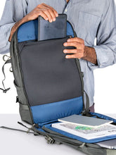 Load image into Gallery viewer, A man sliding a tablet in the main compartment's padded zipper pocket.