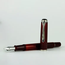 Load image into Gallery viewer, The fountain pen arranged with the cap on the side.