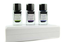 Load image into Gallery viewer, The three ink bottles placed on top of their carrying case.