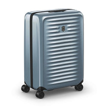 Load image into Gallery viewer, Angled front panel view of the light blue suitcase with the telescopic handle retracted.