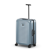 Load image into Gallery viewer, Angled front view of the light blue suitcase with the telescopic handle extended.