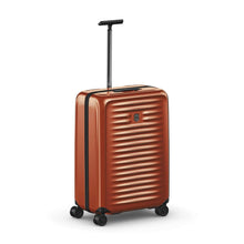Load image into Gallery viewer, Angled front view of the orange suitcase with the telescopic handle extended.