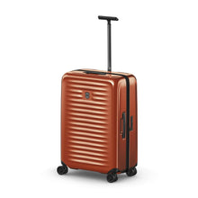 Load image into Gallery viewer, Angled front view of the orange suitcase with the telescopic handle extended.