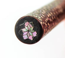 Load image into Gallery viewer, Close up to the abalone shells on the top of the brush's body. Some of the abalone shells have chipped.