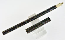 Load image into Gallery viewer, The brush placed with the cap next to it on a pen stand.