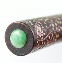 Load image into Gallery viewer, Close up to the green jade cabochon cut stone on the top of the cap.