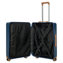 Load image into Gallery viewer, View of the suitcase opened on a white background. The left side features a zipper-closed compartment, and the right side a set of straps to maintain items in place.