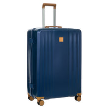 Load image into Gallery viewer, Front angled view of the blue suitcase on a white background. The telescopic handle is pulled up.