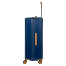 Load image into Gallery viewer, Side view of the blue suitcase on a white background. This side has a tan-brown handle on the middle.