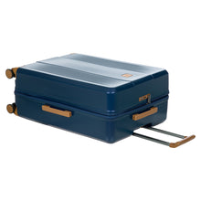 Load image into Gallery viewer, Angled view of the suitcase laid down on a white background. The top of the suitcase features a tan-brown handle and a 3-number combination lock at the center.