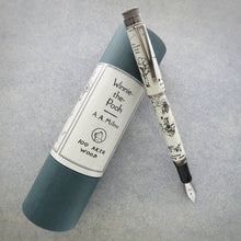 Load image into Gallery viewer, Front view of the 100 Aker Wood fountain pen with the cap posted, while leaning on the gift tube.