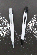 Load image into Gallery viewer, The Retro 51 classic white and the Chaplin side by side. The Chaplin has black trims and also glows in the dark.