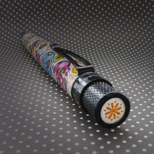 Load image into Gallery viewer, Angled top view of the pen, showing a orange flower icon on the top disk.