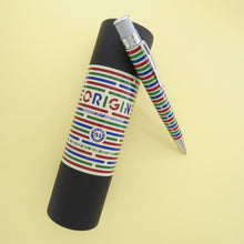 Load image into Gallery viewer, Angled side view of the pen leaning on the matching gift tube. Set on a pastel yellow background.