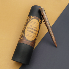 Load image into Gallery viewer, The Retro 51 Smithsonian Woodland Hummingbird and Flowers leaning on the gift tube. Set on an orange and back background.