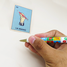 Load image into Gallery viewer, A hand holding the loteria pen with "the hand" card on the background.