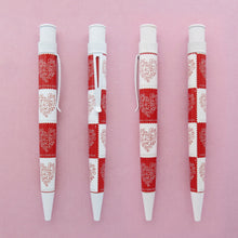 Load image into Gallery viewer, Front, back, and side views of the 2015 love stamp pen on a light pink background.