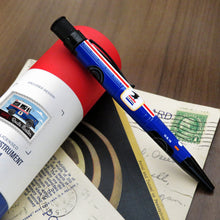 Load image into Gallery viewer, The USPS pen leaning on its gift tube with over a set of postcards.
