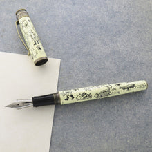 Load image into Gallery viewer, Front view of the Decorations Fountain Pen with the cap set to the side on a textured and white paper.