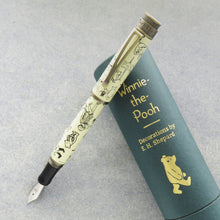 Load image into Gallery viewer, The Decorations fountain pen with the cap posted, leaning on the green gift tube.