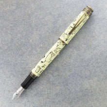 Load image into Gallery viewer, Front view of the Decorations fountain pen with the cap posted. Set on a textured light blue background.