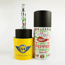 Load image into Gallery viewer, The pen arranged with the matching presentation tube and yellow booklet on a light gray background.