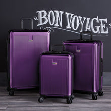 Load image into Gallery viewer, The large, medium, and carry-on sized suitcases on a black background with text: BON VOYAGE.
