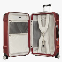 Load image into Gallery viewer, Interior view of the red hard shell suitcase. It features a zipper-closing panel divider, pockets, and adjustable straps .