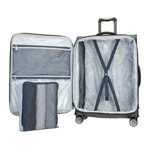 Load image into Gallery viewer, Interior view of the gray suitcase with a small packing bag next to it.