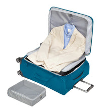 Load image into Gallery viewer, Interior view with a suit hanging from the front panel on the teal suitcase.