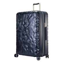 Load image into Gallery viewer, Angled front panel view of the navy blue suitcase with geometric texture.