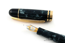 Load image into Gallery viewer, Close up to the nib with the cap next to it.
