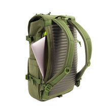Load image into Gallery viewer, Angled back panel view of the olive green backpack showing a laptop peeking from the side of back panel's compartment.