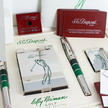 Load image into Gallery viewer, The pens and lighters arranged in their presentation box with the booklets and certificates.