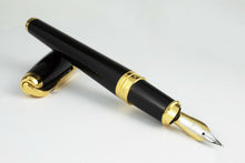 Load image into Gallery viewer, The fountain pen resting on the cap.