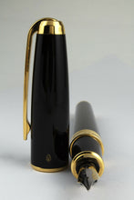Load image into Gallery viewer, Angled view of the fountain pen with the cap next to it.