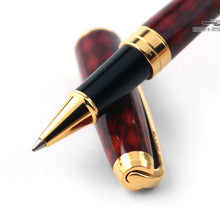 Load image into Gallery viewer, Close up to the pen's grip section resting on the cap on a white background.