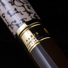 Load image into Gallery viewer, Close up to the golden band by the grip section. It is engraved with PARIS, the edition number, and MADE IN FRANCE.